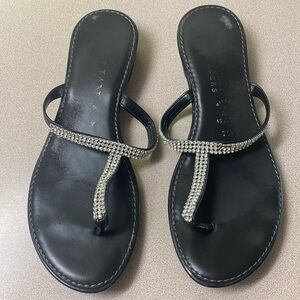Black,  jeweled, flip-flop sandal.